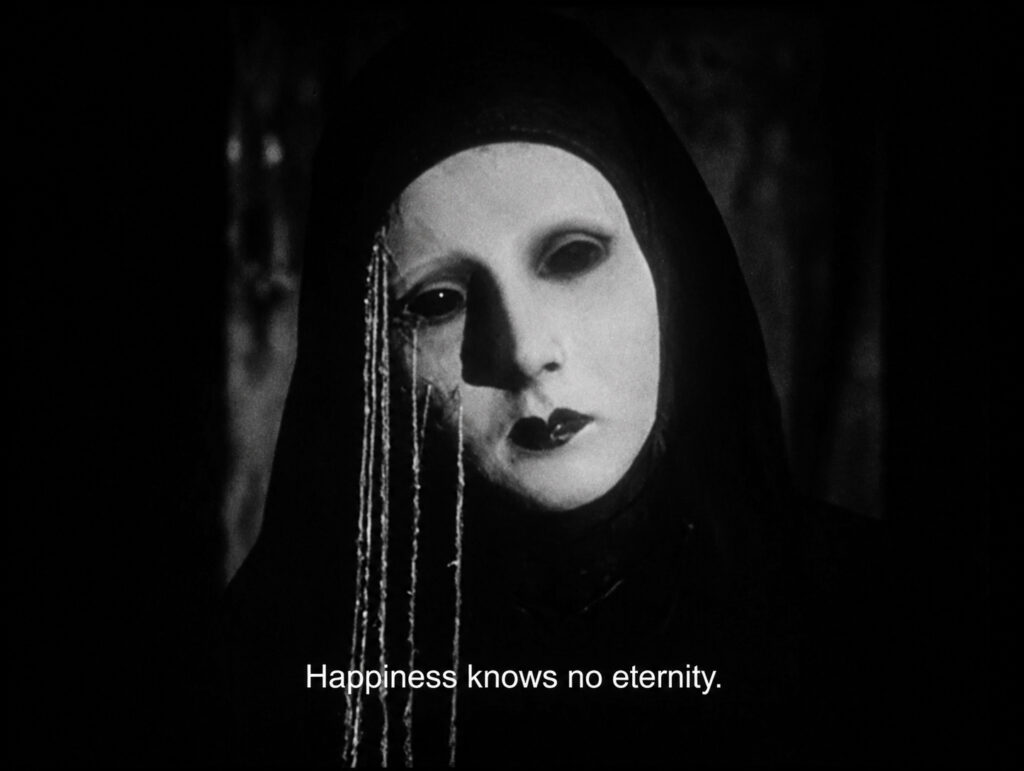 Black-and-white film still of a masked figure — The Films That Only You Can Make